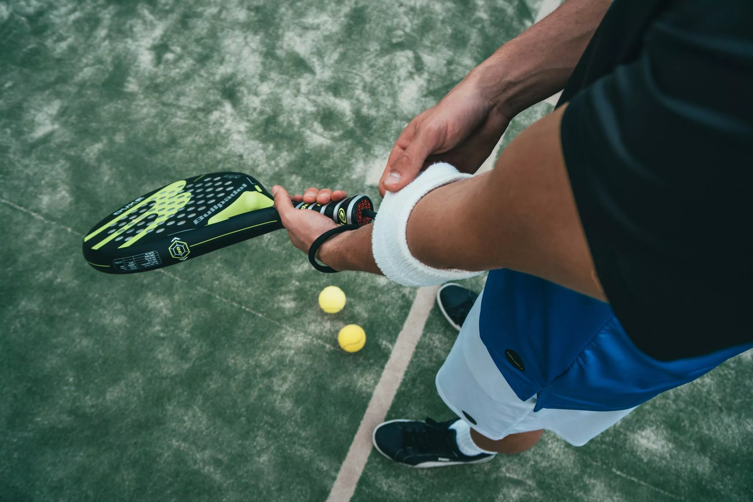 Homme avec raquette de padel et balles